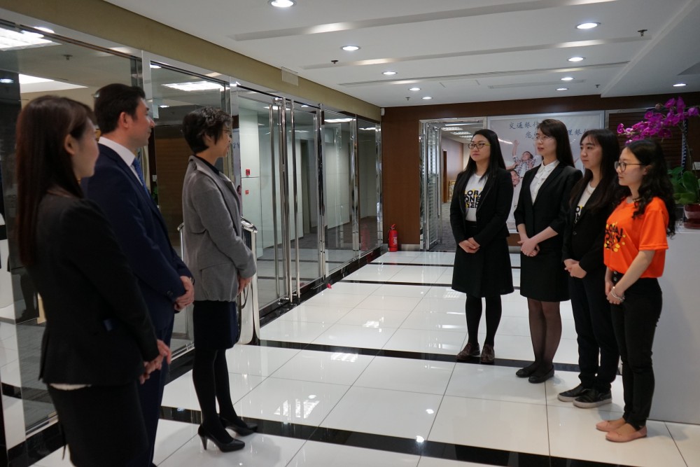 Bank of Communications representatives distribute work to students