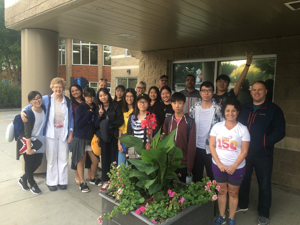 Group photo of students and the host families